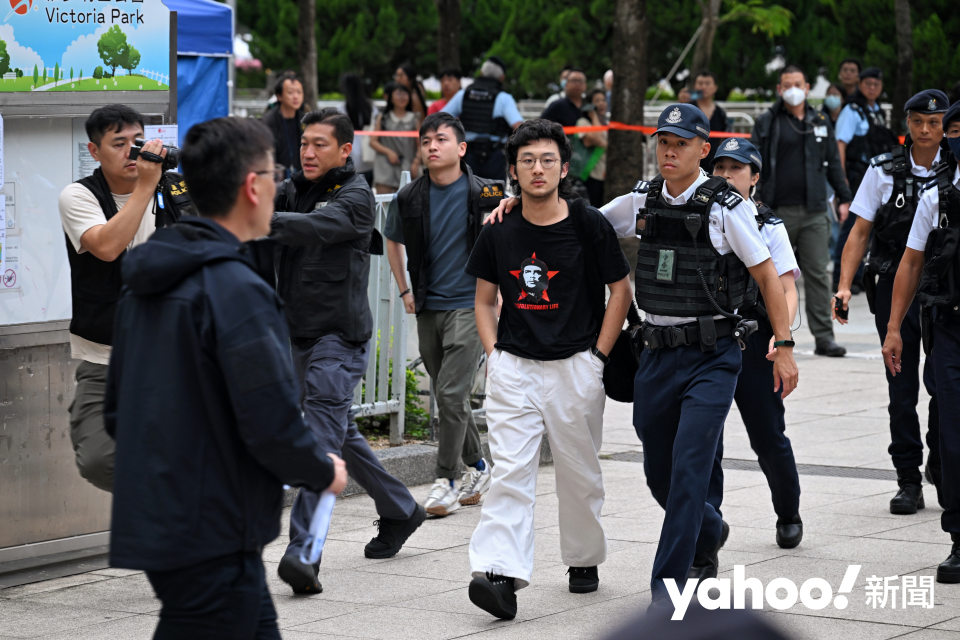 The man is wearing a black T-shirt with the image of Inje Guwara