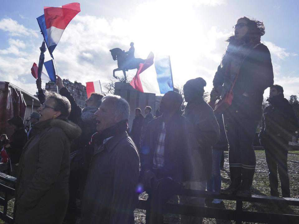 Supporters of conservative presidential candidate Francois Fillon listen during a rally in Paris, Sunday, March 5, 2017. The rally across from the Eiffel Tower is meant to gauge Fillon's remaining support after numerous defections by conservative allies just seven weeks before the first round of the April-May election. Fillon faces corruption charges. (AP Photo/Thibault Camus)