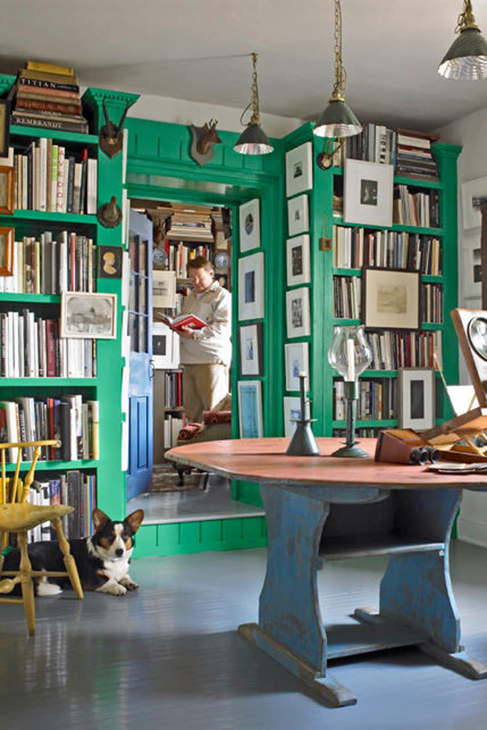 room with green bookcases