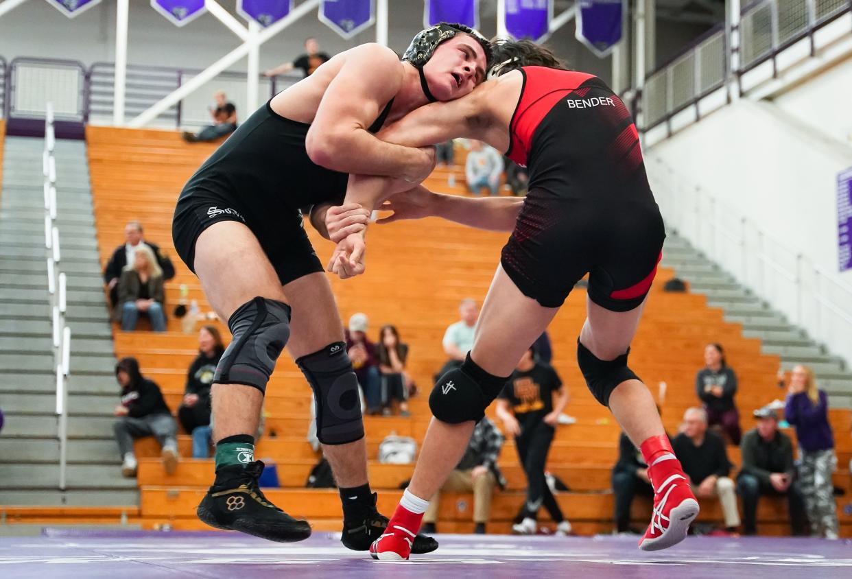 Bloomington South’s Evan Roudebush (left) wrestles against Terre Haute South’s Coy Bender in the 165-pound final during the IHSAA wrestling regional at Bloomington South on Saturday, Feb. 3, 2024.