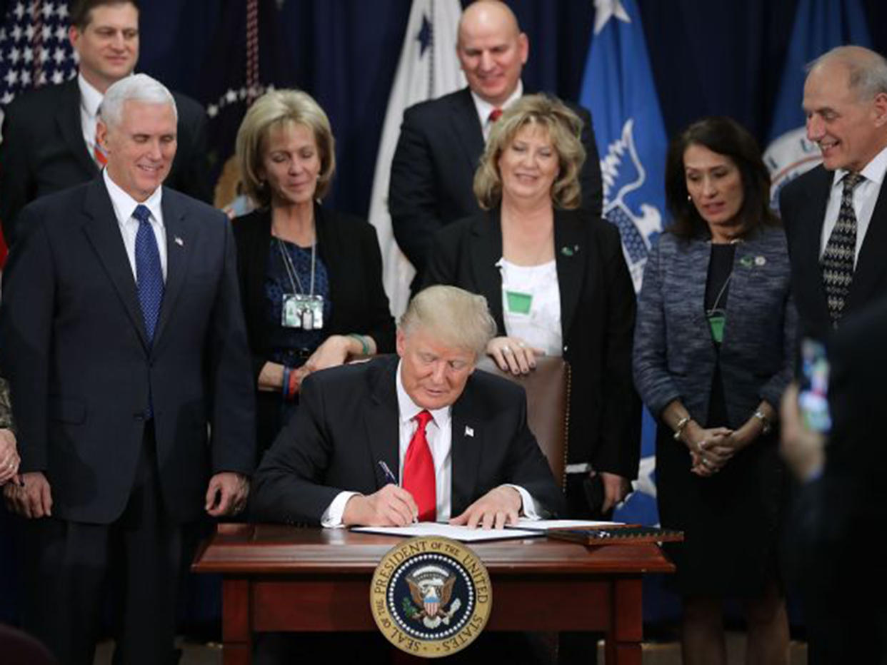 The US President signed a number of his most extreme immigration policies into law on Wednesday: Getty