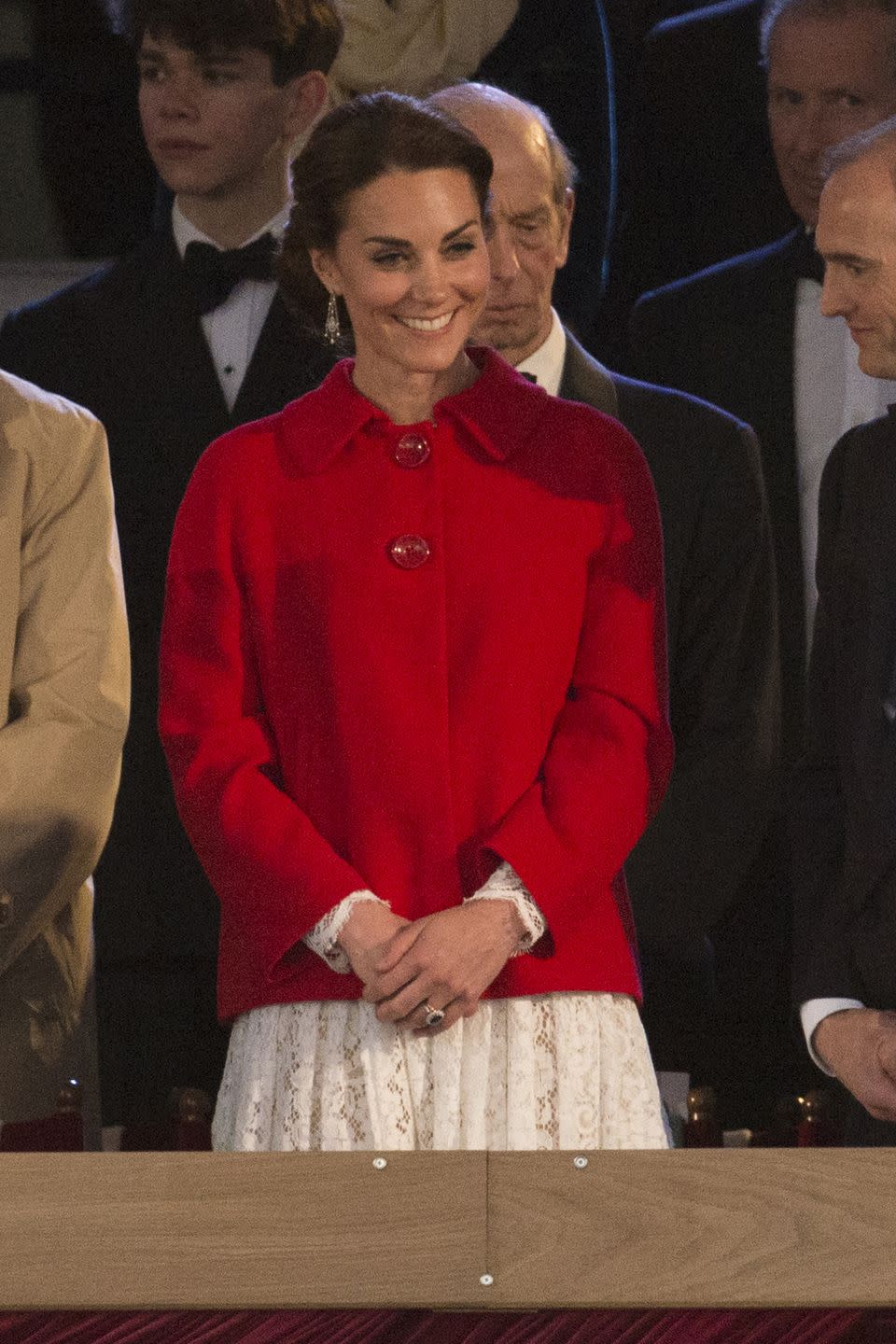 <p>Middleton was all smiles at Queen Elizabeth II's 90th birthday celebration. She mixed high and low pieces for the occasion, layering a crimson Zara coat over her lace Dolce & Gabbana dress. </p>