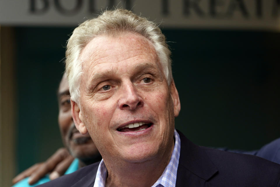 FILE - In this May 29, 2021, file photo, Democratic gubernatorial candidate, former Gov. Terry McAuliffe smiles during a tour of downtown Petersburg, Va. McAuliffe won Virginia's 2013 governor's race by embracing his own brand of personal politics that rely on decades-old friendships, back-slapping charisma and tell-it-like-it-is authenticity. (AP Photo/Steve Helber, File)