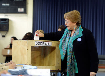 Chile's President Michelle Bachelet casts her ballot during the mayors and councillors elections in Santiago, Chile, October 23, 2016. Alex Ibanez/Courtesy of Chilean Presidency/Handout via Reuters