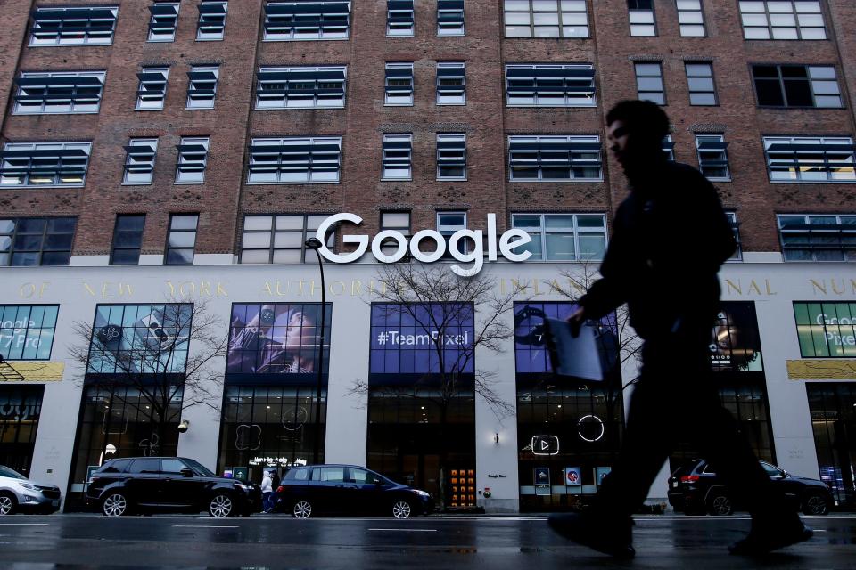 A man walking past Google's offices in New York.