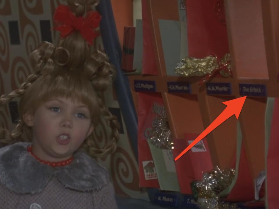 arrow pointing at grinch mailbox behind cindy lou who in how the grinch stole christmas