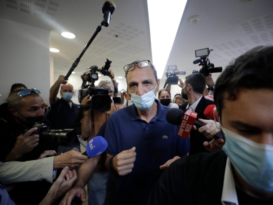 Shmulik Peleg, who spirited away his grandson Eitan Biran from Italy, is surrounded by the media as he leaves court in Tel Aviv (AP)