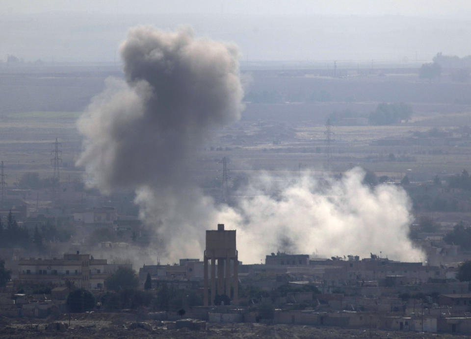 In this photo taken from the Turkish side of the border between Turkey and Syria, in Ceylanpinar, Sanliurfa province, southeastern Turkey, smoke billows from targets in Ras al-Ayn, Syria, caused by bombardment by Turkish forces, Wednesday, Oct. 16, 2019. (AP Photo/Lefteris Pitarakis)