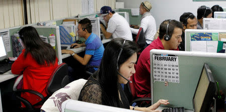Call center agents work overnight daily to cater to United States clients in Manila's Makati financial district February 6, 2012. REUTERS/Erik De Castro/File Photo