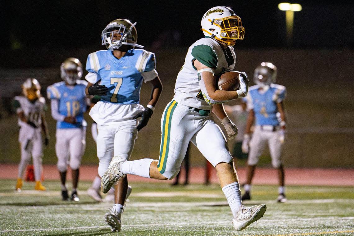 Rio Americano Raiders running back Trace Kloss (22) walks into the endzone for the touchdown during the first half of the game at Del Campo High School on Friday.