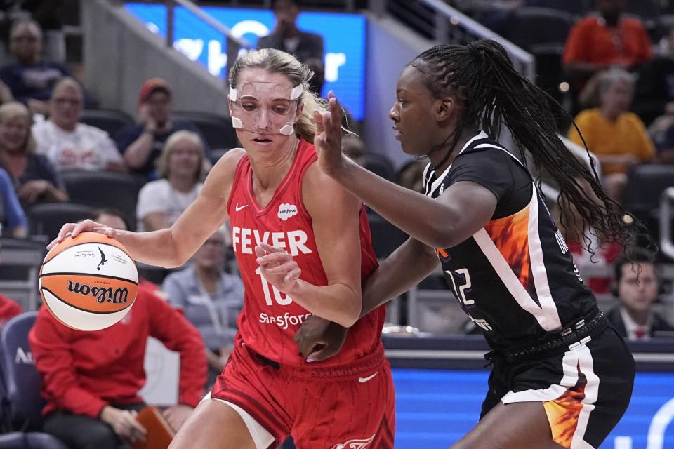 Indiana Fever's Lexie Hull (10) is defended by Phoenix Mercury's Michaela Onyenwere during the first half of a WNBA basketball game, Tuesday, Aug. 1, 2023, in Indianapolis. (AP Photo/Darron Cummings)