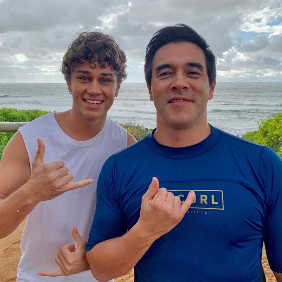 Matt Evans and James Stewart stand on Palm Beach smilling at the camera