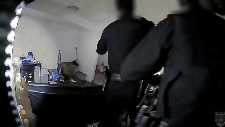 This image from a body camera provided by the Carol Stream Police Dept. shows the fatal shooting of a 30-year-old man inside his apartment. Isaac Goodlow III died at a hospital after he was shot Feb. 3 in Carol Stream, about 34 miles (55 kilometers) west of Chicago. (Carol Stream Police Dept. via AP)