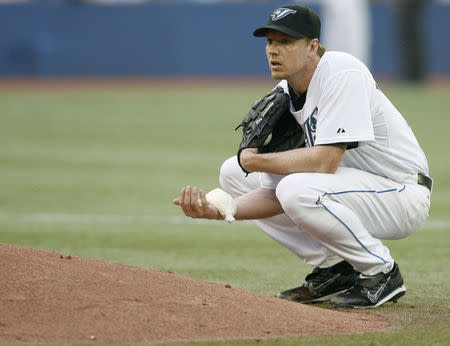 Toronto Blue Jays starter Roy Halladay holds the rosin bag during a break in play during the sixth inning of their American League MLB baseball game against the Chicago White Sox in Toronto May 31, 2007. REUTERS/J.P. Moczulski