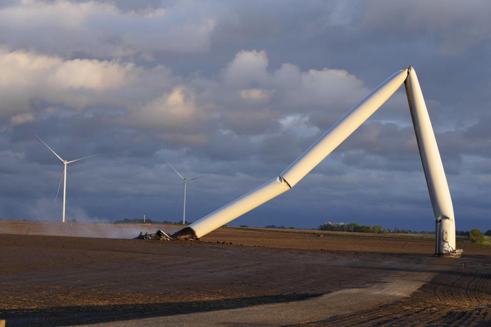 The remains of a tornado-damaged wind turbine touch the ground in a field, Tuesday, May 21, 2024, near Prescott, Iowa. (AP Photo/Charlie Neibergall)