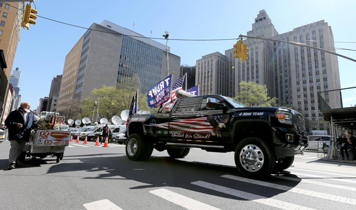 A pickup truck adorned with Trump flags drives down Lafayette Street near the NY Criminal Court where jury selection got underway in Former President Donald Trump's crimiminal trial Monday, April 15, 2024.