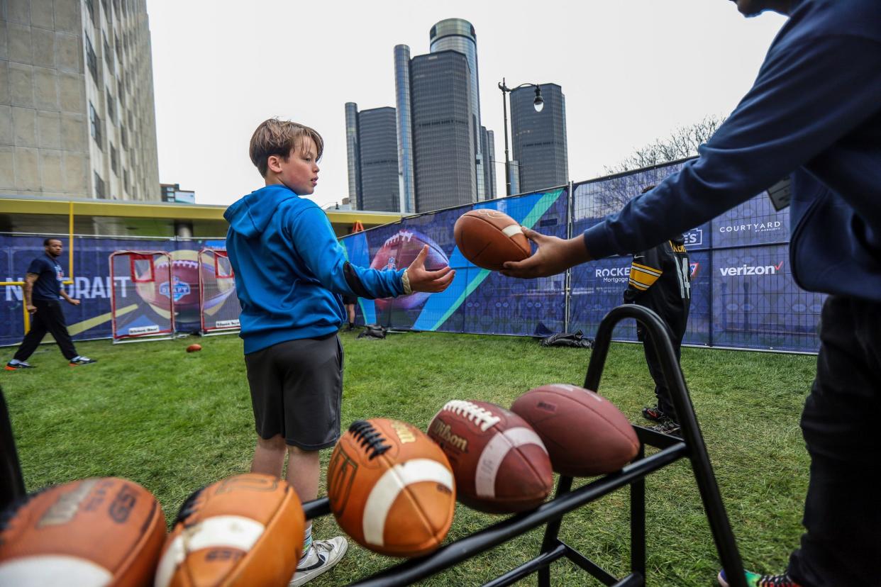 Carson Rugh, 11, of Plymouth, throws the football in the Play:60 Kick/Toss at the NFL Draft Experience in downtown Detroit on Saturday, April 27, 2024.