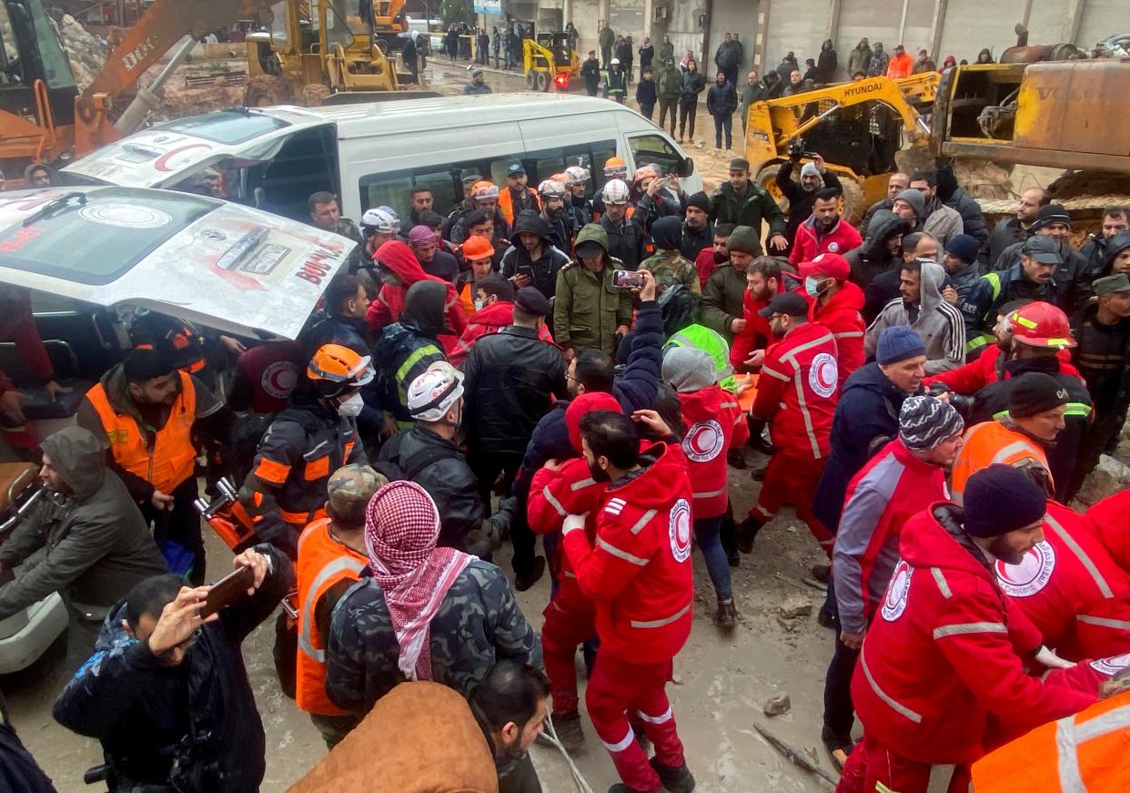 Rescuers work near the site of a collapsed building, following an earthquake, in Hama, Syria (REUTERS)