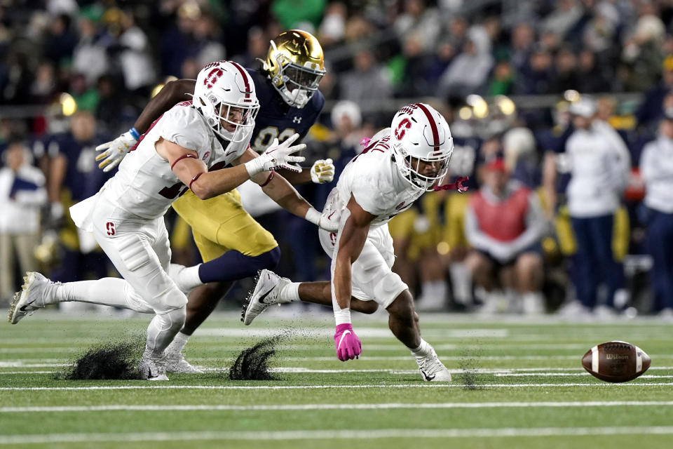 Stanford safety Jonathan McGill, right, and cornerback Ethan Bonner, left, and Notre Dame wide receiver Jayden Thomas chase a fumble during the second half of an NCAA college football game in South Bend, Ind., Saturday, Oct. 15, 2022. Stanford won 16-14. (AP Photo/Nam Y. Huh)