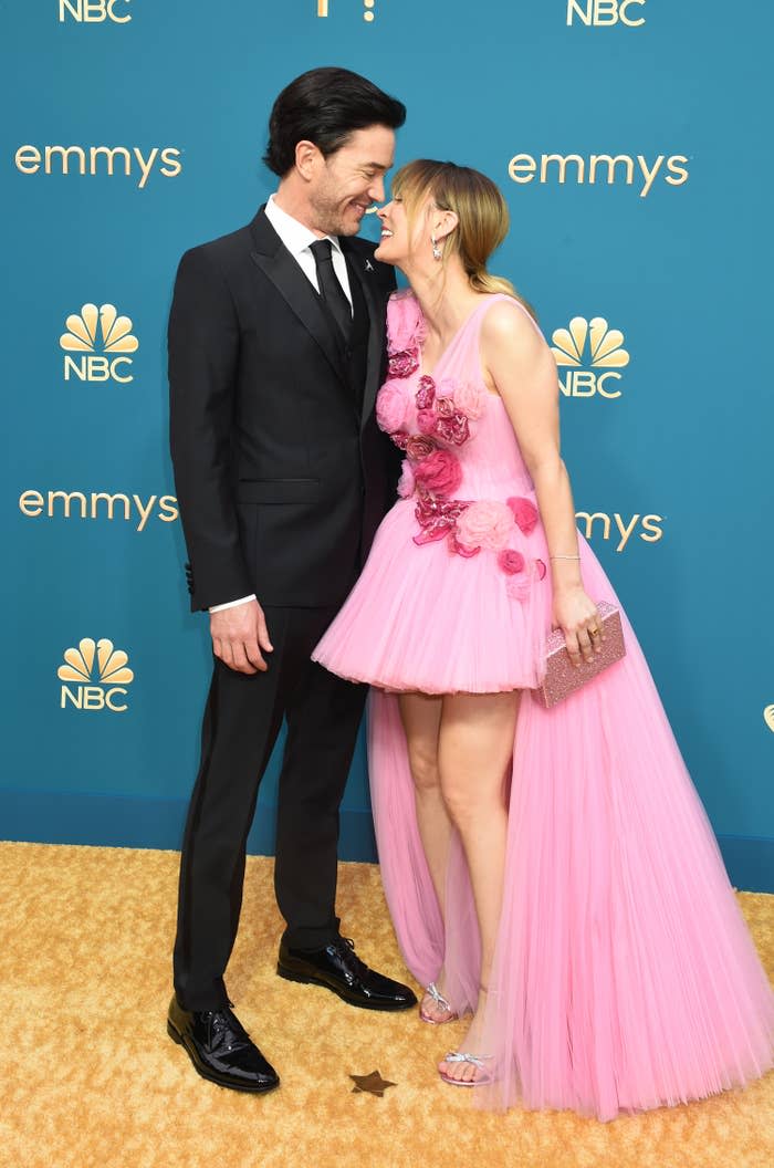 Kaley and Tom hold their faces close together and smile
