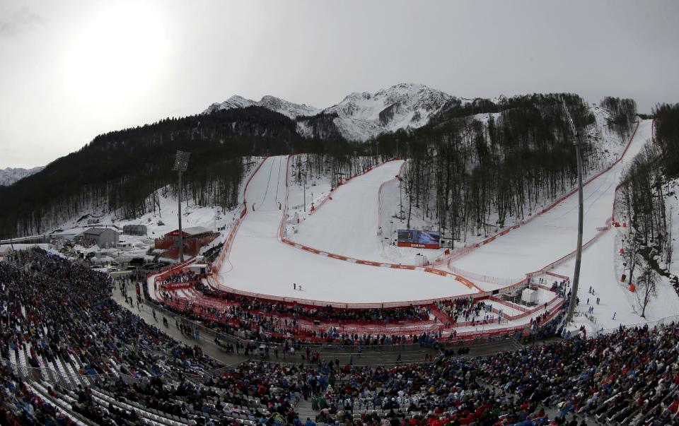 In this photo taken with a fisheye lens, the Rosa Khutor Alpine center is seen during the men's downhill event at the 2014 Winter Olympics, Sunday, Feb. 9, 2014, in Krasnaya Polyana, Russia. (AP Photo/Charlie Riedel)