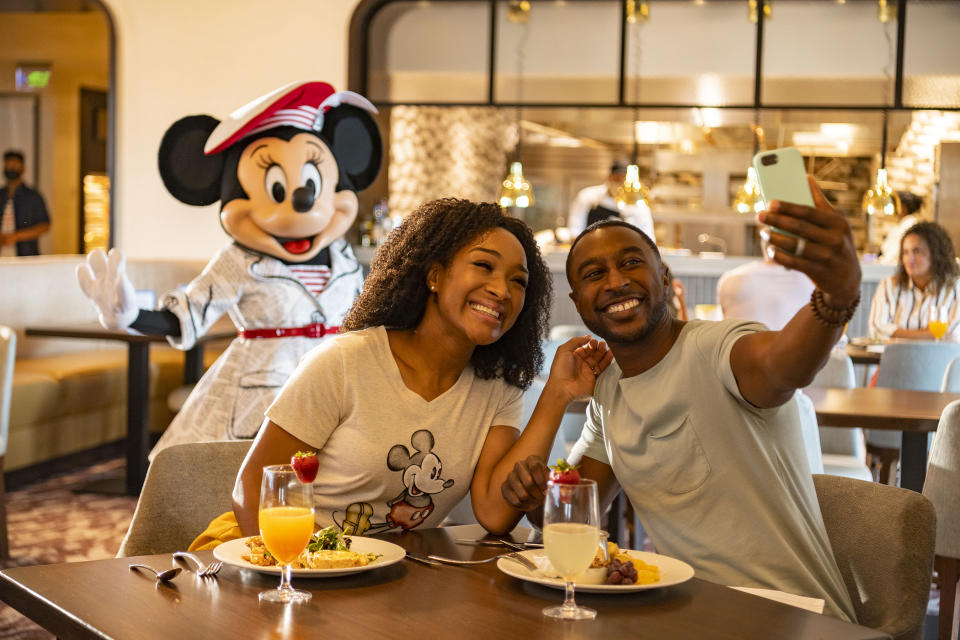 Guests at Disney's Riviera Resort at Walt Disney World Resort in Lake Buena Vista, Fla., can see Mickey Mouse, Minnie Mouse, Donald Duck and Daisy Duck during breakfast at Topolino's Terrace - Flavors of the Riviera, the resort's rooftop restaurant. During the resort's phased reopening, characters maintain proper physical distancing while parading through the restaurant during mealtimes. (Disney/Matt Stroshane)