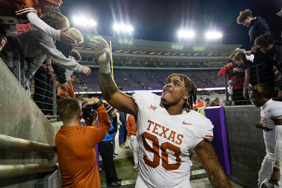 Texas defensive tackle Byron Murphy II shakes hands with fans as he leaves the field at Amon G. Carter Stadium in Fort Worth after the Longhorns' 29-26 win in November. Murphy, who starred at nearby DeSoto High School, is heading to Seattle after the Seahawks selected him with the 16th overall pick of the NFL draft.