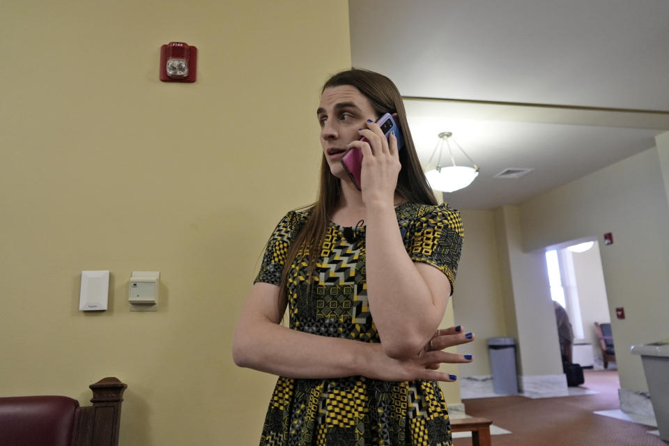 CORRECTS FIRST NAME TO MATT, NOT MARK REGIER - State Rep. Zooey Zephyr speaks on the phone after House Speaker Matt Regier told her she could not work from the hallway just outside the main chamber of the House, Thursday, April 27, 2023 in Helena, Mont. Zephyr was barred from participating on the House floor as Republican leaders voted Wednesday to silence her for the rest of 2023 session after she protested GOP leaders' decision earlier in the week to silence her. (AP Photo/Brittany Peterson)