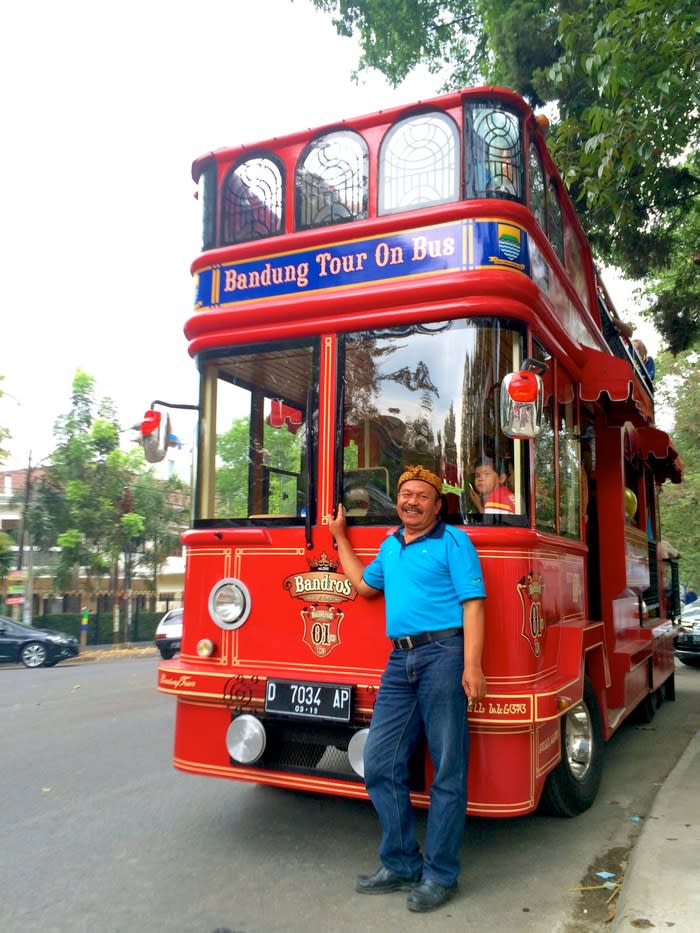 Bus Captain: Pak Dadang, Bandros's driver posing in front of the stylish city tour bus.