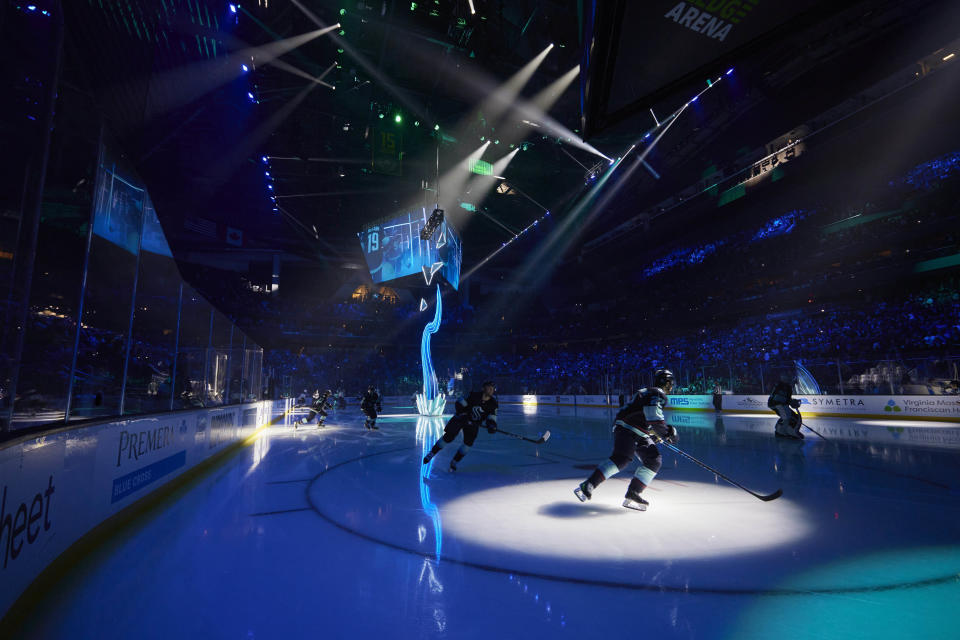 A light sculpture is projected during pregame introductions of the Seattle Kraken NHL hockey team before a game against the St. Louis blues in Seattle, Wednesday, Oct. 19, 2022. With Hollywood filmmaker Jerry Bruckheimer as part of the ownership group, the Seattle Kraken were always going to have a big cinematic element to any video production the team produced. An original compostion by Grammy and Oscar Award winning composer Hans Zimmer was created specifically for the Kraken. (AP Photo/John Froschauer)