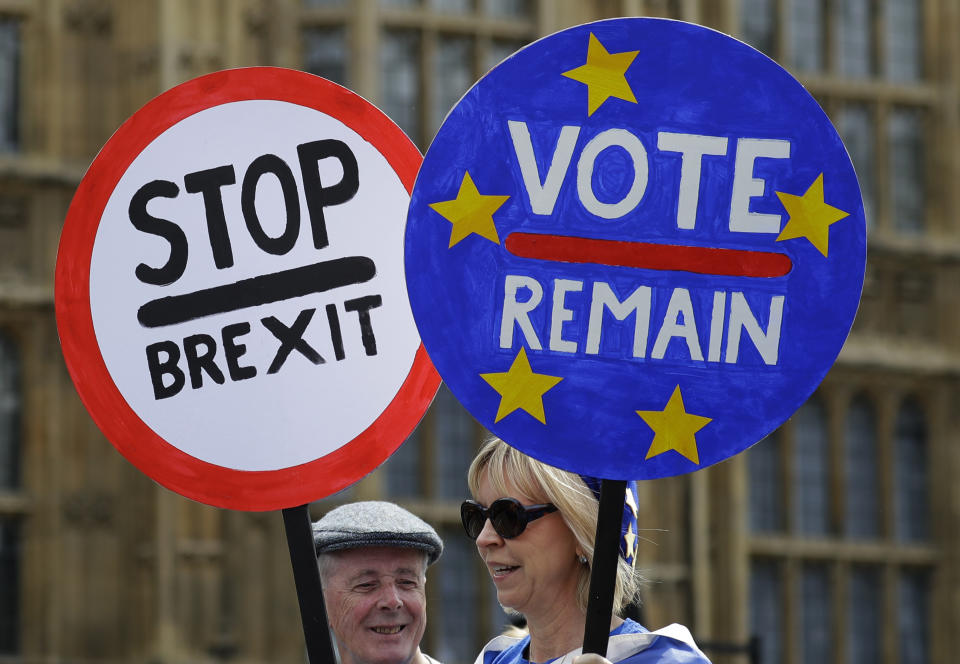 Anti Brexit campaigners hold banners near Parliament in London, Wednesday, May 22, 2019. British Prime Minister Theresa May was under pressure Wednesday to scrap a planned vote on her tattered Brexit blueprint — and to call an end to her embattled premiership — after her attempt at compromise got the thumbs-down from both her own Conservative Party and opposition lawmakers. (AP Photo/Kirsty Wigglesworth)