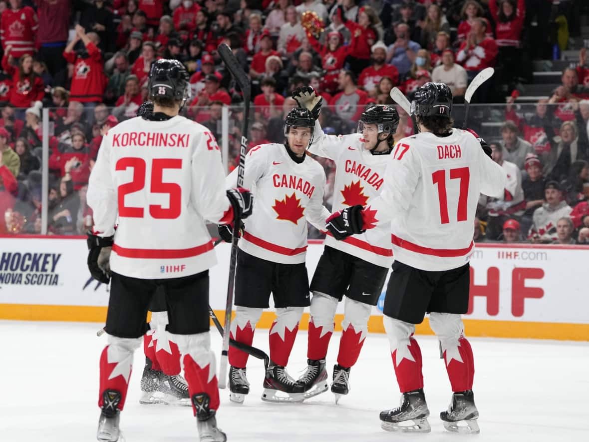 Canada celebrates a win over Austria at the 2023 IIHF World Junior Hockey Championship. The Fables' recording of Heave Away rang out each time the team scored a goal. (Darren Calabrese/The Canadian Press - image credit)
