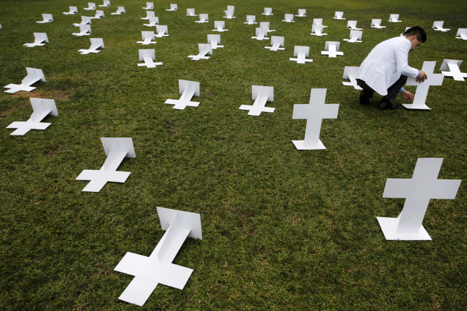 <p>A protester sets up paper grave markers during a protest against the visit of Zhang Dejiang, chairman of China’s National People’s Congress, to Hong Kong on May 17, 2016. Hong Kong authorities rolled out a massive security operation on Tuesday as they braced for protests during a top Beijing official’s visit to the semiautonomous city, which has been the scene of rising discontent with Chinese rule. (Vincent Yu/AP)</p>