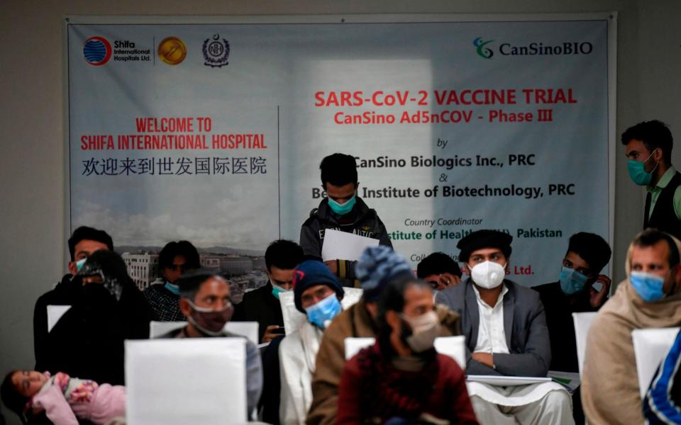 Volunteers wait to be administered the new Chinese-made Covid-19, the first ever Phase 3 clinical trial for any vaccine in Pakistan, at a hospital in Islamabad - Aamir QURESHI / AFP