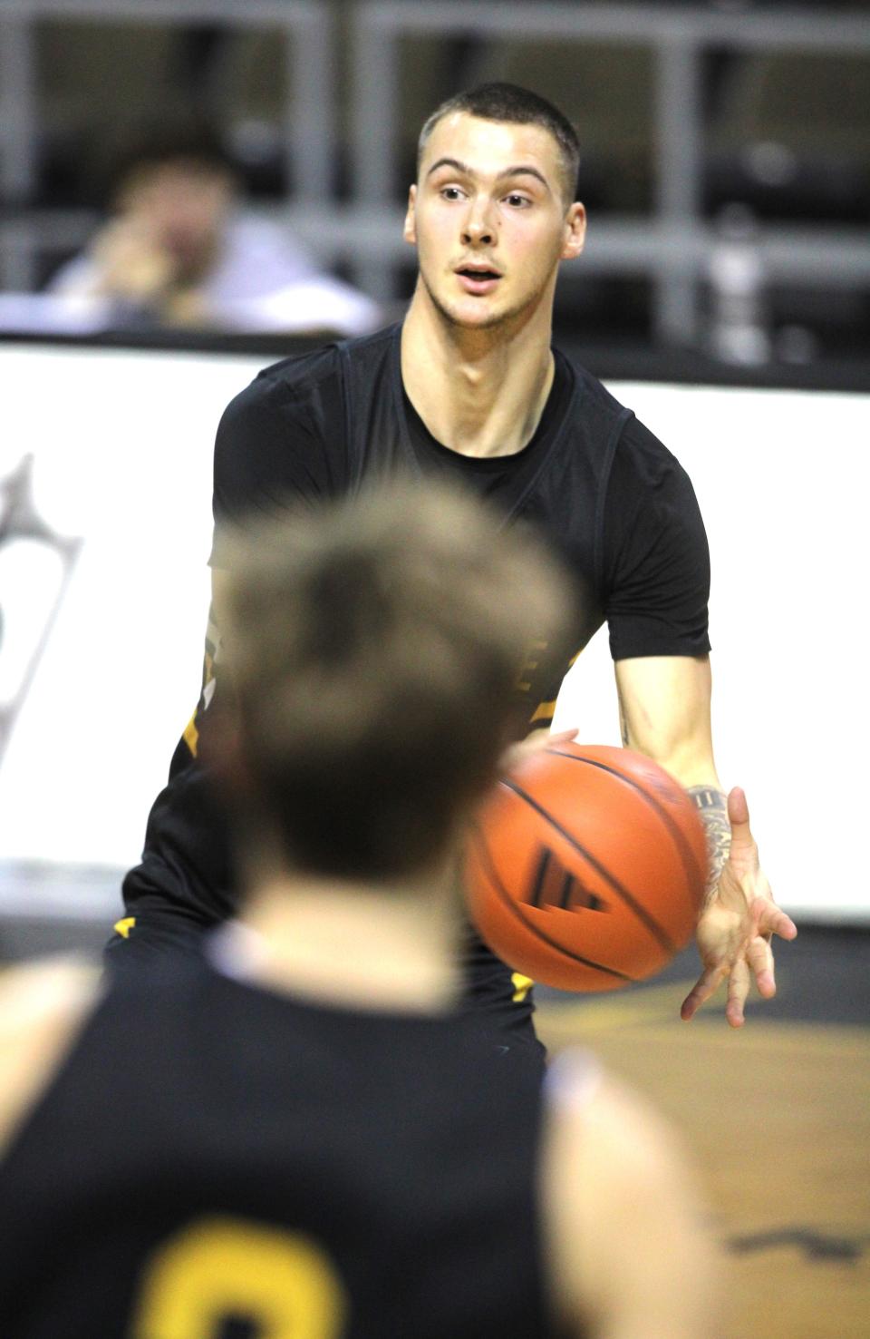 NKU junior forward Cade Meyer, a transfer from Green Bay, passes the ball as Northern Kentucky University men's basketball team had preseason practice Oct. 26, 2023, at Truist Arena.