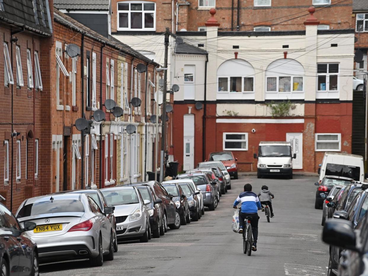 Children cycle in North Evington, one of the worst-hit areas of Leicester: AFP via Getty Images