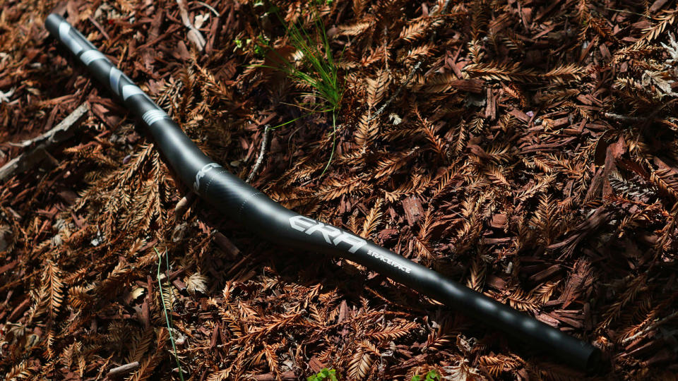 Race Face Era handlebar against a wood chip back drop