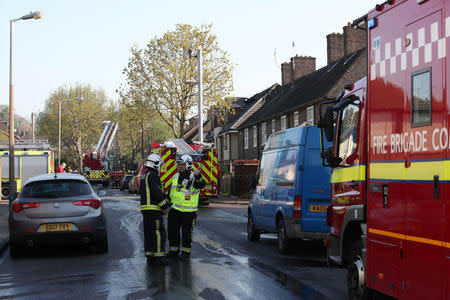 Firefighters stand on the street at the scene of a large fire in a residential care home in Connington Crescent, Chingford, north-east London, Britain, April 20, 2018. REUTERS/Chris Radburn