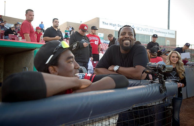 Former Angels outfielder Vladimir Guerrero, center, visits with his nephew and Mavericks right fielder Gabriel Guerrero, left, before being introduced at Wednesday's game in Adelanto. It was the first time Vladimir had been able to watch his nephew play.