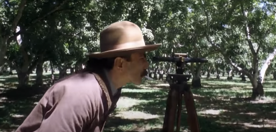 A person outside looking through a small telescope