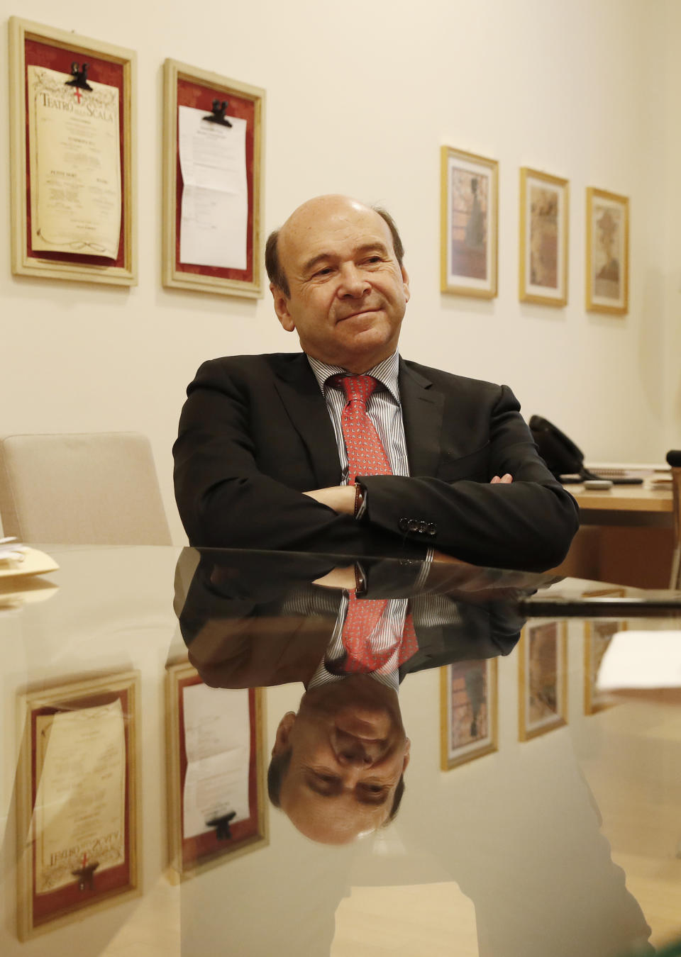 La Scala new general manager Dominique Meyer talks during an interview with The Associated Press, in Milan, Italy, Friday, Nov. 22, 2019. Sitting at a round glass table inside his new La Scala office, Meyer considers the transition to the new role, from a public repertory theater with 50 opera titles a year, to La Scala, one of the world’s leading opera and ballet theaters, presenting some 15 opera titles a year. (AP Photo/Antonio Calanni)