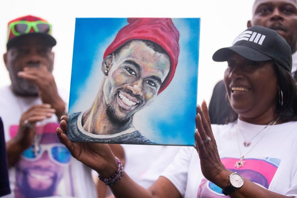 RowVaughn Wells, the mother of Tyre Nichols, holds up a painting of her son given to her by artist Jason Johnson during the celebration for what would have been Nichols’ 30th birthday at Fourth Bluff Park in Downtown Memphis on Monday, June 5, 2023. 