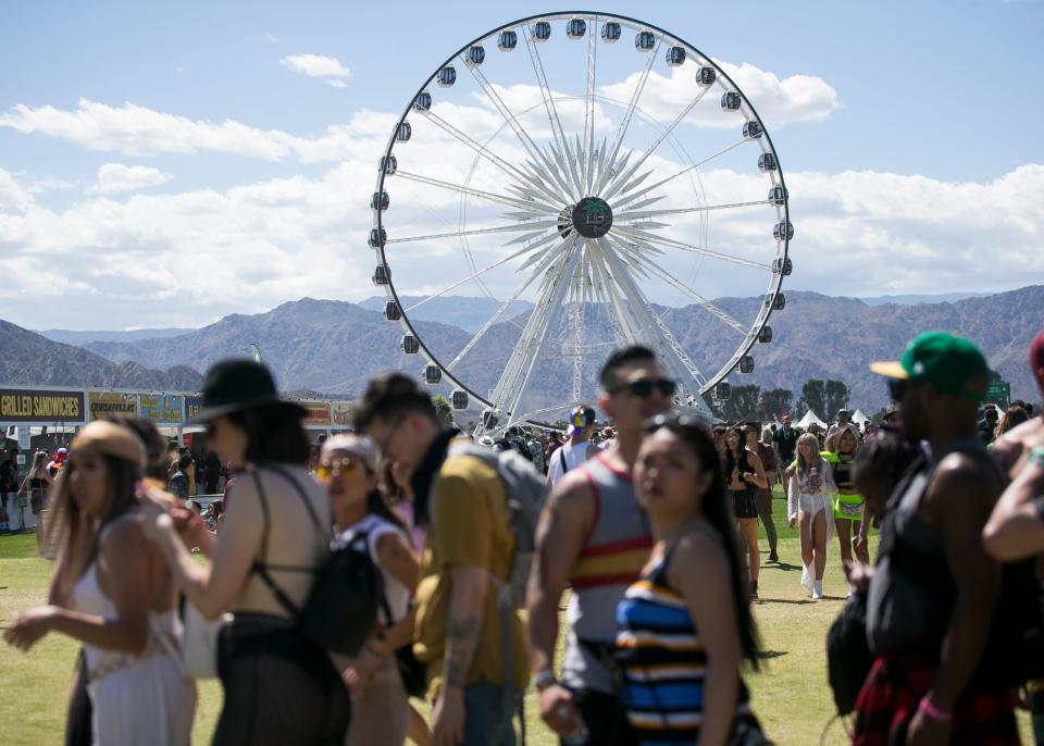 Festival goers walk past the ferris wheel at the Coachella Valley Music and Arts Festival in Indio, Calif. on Fri. April 12, 2019. 