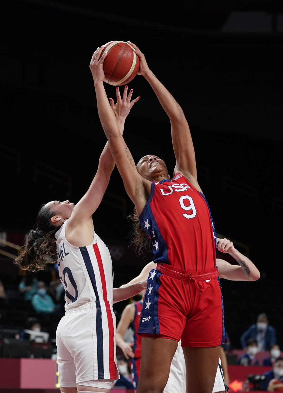 France's Sarah Michel (10), left, and United States' A'Ja Wilson (9) fight for the ball during women's basketball preliminary round game at the 2020 Summer Olympics, Monday, Aug. 2, 2021, in Saitama, Japan. (AP Photo/Charlie Neibergall)