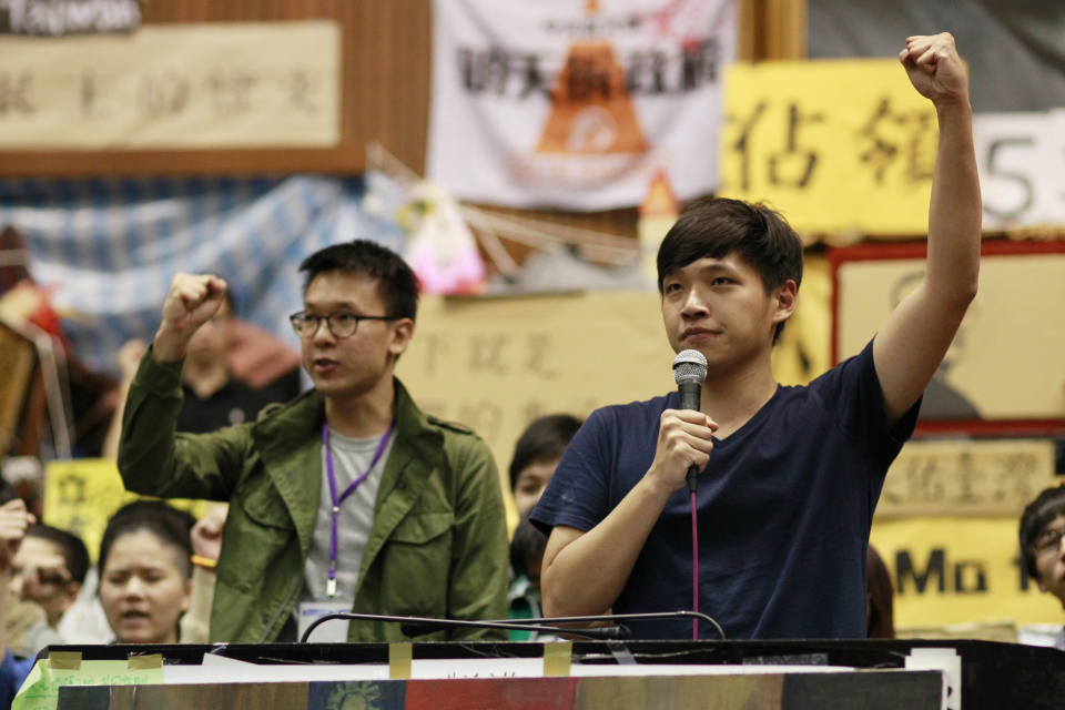 Lin Fei-fan, left, and Chen Wei-ting, leaders of the student protests against a trade pact with China, speak to the media during a press conference on the occupied legislature floor in Taipei, Taiwan, Monday, April 7, 2014. During a press conference Monday night, student leaders said they would end their 3-week-old occupation of the legislature but continue to protest against a trade pact with China, which has been challenging the president's policy of moving the democratic island economically closer to China. (AP Photo/Wally Santana)