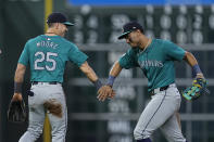 Seattle Mariners shortstop Dylan Moore (25) celebrates with center fielder Julio Rodríguez, right, after a baseball game against the Houston Astros, Saturday, May 4, 2024, in Houston. (AP Photo/Kevin M. Cox)