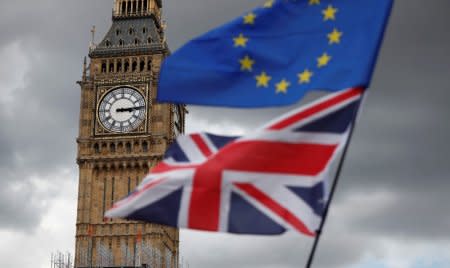 FILE PHOTO: The Union Flag and a European Union flag fly near the Elizabeth Tower, housing the Big Ben bell, during the anti-Brexit 'People's March for Europe', in Parliament Square in central London, Britain September 9, 2017.   REUTERS/Tolga Akmen