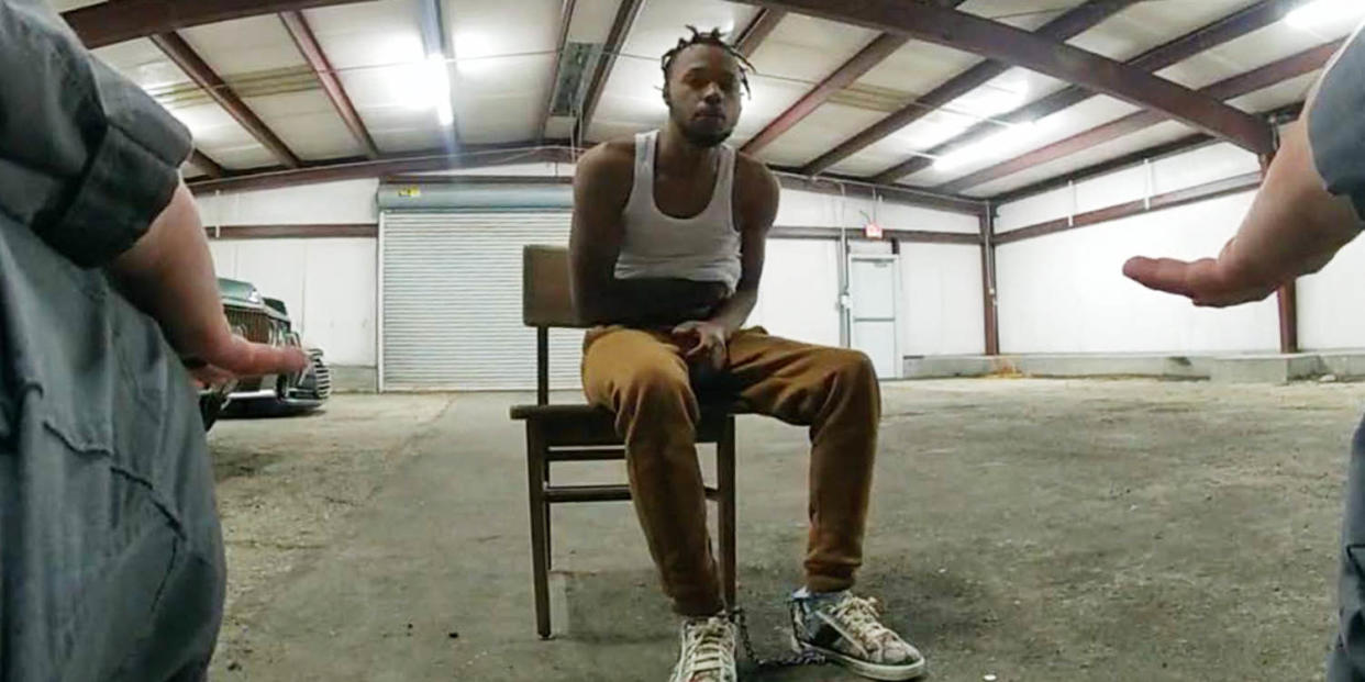 Baton Rouge police officers 
question Jeremy Lee at the warehouse they reportedly call the 