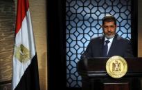 FILE PHOTO - Muslim Brotherhood's president-elect Mohamed Mursi speaks during his first televised address to the nation in Cairo