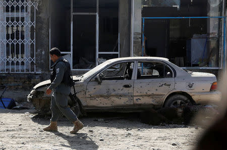 An Afghan policeman inspects the site of a suicide attack near a large Shi'ite mosque, Kabul, Afghanistan. September 29, 2017. REUTERS/Omar Sobhani